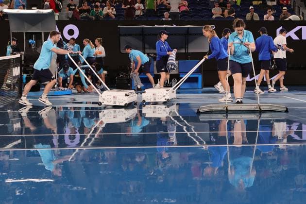 Rain delay as staff mop up the water before roof closure in the match between Elena Rybakina of Kazakistan and Jelena Ostapenko of Latvia during the Quarter Final, Day 9 at the Australian Open Tennis 2023 at Rod Laver Arena, Melbourne, Australia on 24 January 2023. Copyright: xPeterxDovganx 34781919