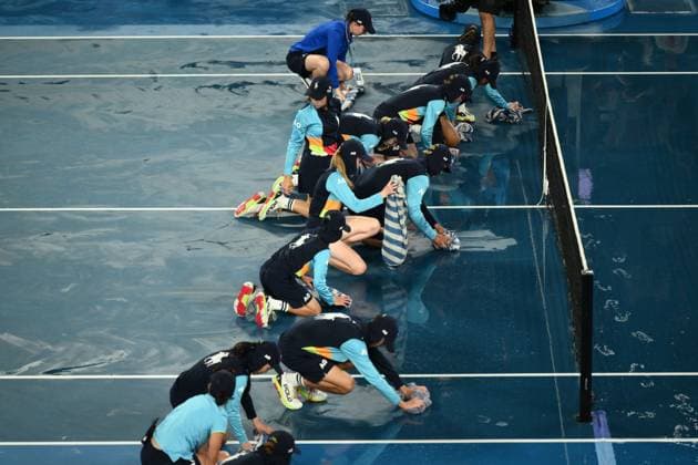 Mandatory Credit: Photo by James Gourley Shutterstock (13729783at) Ballkids clear the court after rain on the court stops play between Jelena Ostapenko and Elena Rybakina in their Quarter Final Match Australian Open, Day Nine, Tennis, Melbourne Park, Melbourne, Australia - 24 Jan 2023 Australian Open, Day Nine, Tennis, Melbourne Park, Melbourne, Australia - 24 Jan 2023  Copyright: xJamesxGourley Shutterstockx 13729783at