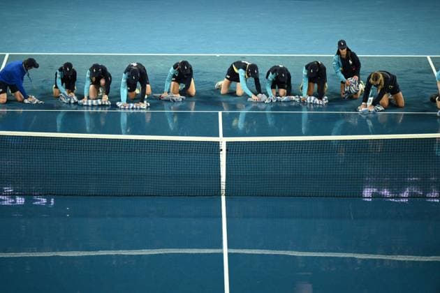 Mandatory Credit: Photo by James Gourley Shutterstock (13729783aq) Ballkids clear the court after rain on the court stops play between Jelena Ostapenko and Elena Rybakina in their Quarter Final Match Australian Open, Day Nine, Tennis, Melbourne Park, Melbourne, Australia - 24 Jan 2023 Australian Open, Day Nine, Tennis, Melbourne Park, Melbourne, Australia - 24 Jan 2023  Copyright: xJamesxGourley Shutterstockx 13729783aq