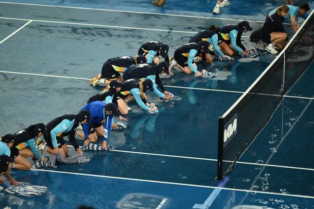 Mandatory Credit: Photo by James Gourley Shutterstock (13729783ao) Ballkids clear the court after rain on the court stops play between Jelena Ostapenko and Elena Rybakina in their Quarter Final Match Australian Open, Day Nine, Tennis, Melbourne Park, Melbourne, Australia - 24 Jan 2023 Australian Open, Day Nine, Tennis, Melbourne Park, Melbourne, Australia - 24 Jan 2023  Copyright: xJamesxGourley Shutterstockx 13729783ao