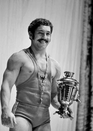 Moscow, USSR. World and European champion in the clean and jerk Rolf Milser from the Federal Republic of Germany at the award ceremony of the winners in the first heavyweight stands on the podium at the 29th (49th) World Weightlifting Championships at the Sports Palace of the Central Lenin Stadium. Valentin Kuzmin, Vyacheslav Un Da-Sin TASS  17533044