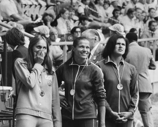 Montreal, Canada. East German athlete Johanna Schaller (gold) and Soviet athletes Tatyana Anisimova (silver) and Natalya Lebedeva (bronze) (L-R) participate in the award ceremony of 100 metres hurdles competition medalists at the 1976 Summer Olympics at the Olympic Stadium. Viktor Budan, Yashar Khalilov TASS  17607012