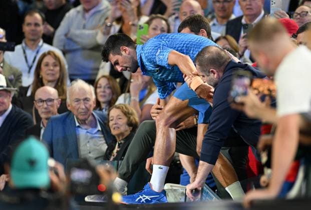 TENNIS AUSTRALIAN OPEN, Novak Djokovic of Serbia is assisted from the players box after winning the men?s singles final against Stefanos Tsitsipas of Greece at the 2023 Australian Open tennis championship at Melbourne Park in Melbourne, Sunday, January 29, 2023. ( NO ARCHIVING, EDITORIAL USE ONLY, NO USE IN BOOKS WITHOUT CONSENT MELBOURNE VICTORIA AUSTRALIA  Copyright: xJamesxRossx 20230129001757917424