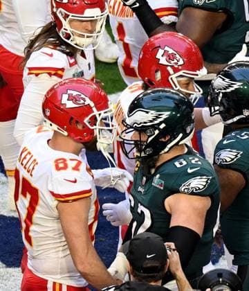 Kansas City Chiefs tight end Travis Kelce (87) greets his brother Philadelphia Eagles center Jason Kelce (62) before Super Bowl LVII at State Farm Stadium in Glendale, Arizona, on Sunday, February 12, 2023.  SBP20230212417 JONxSOOHOO