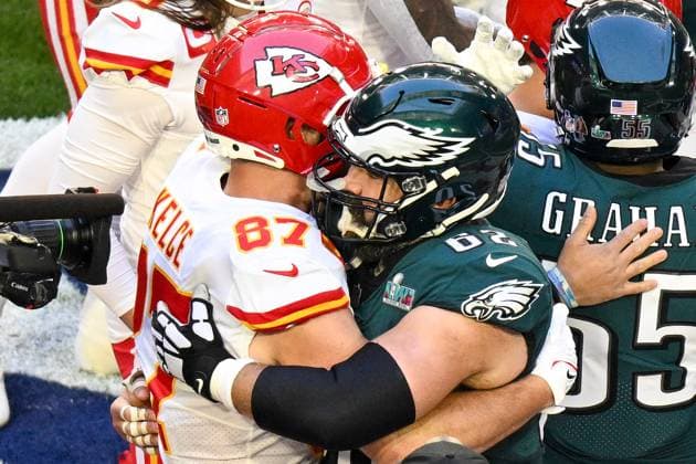 Kansas City Chiefs tight end Travis Kelce (87) greets his brother Philadelphia Eagles center Jason Kelce (62) before Super Bowl LVII at State Farm Stadium in Glendale, Arizona, on Sunday, February 12, 2023.  SBP20230212418 JONxSOOHOO