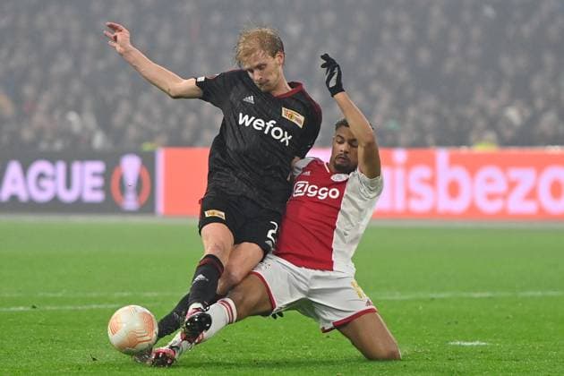 AMSTERDAM, 16-02-2023 , JohanCruyff Arena, season 2022 2023 , Europa League match between Ajax and Union Berlin, Ajax player Devyne Rensch with Union Berlin player Morten Thorsby during the match Ajax - Union Berlin Ajax - Union Berlin  x19917530x Copyright: