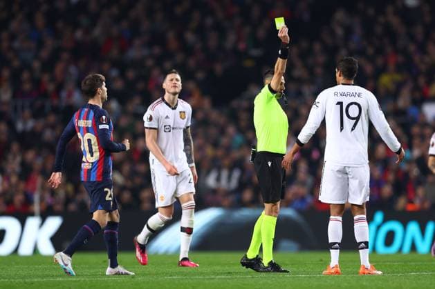 Mandatory Credit: Photo by Simon Dael Shutterstock (13765759u) Raphael Varane of Manchester United, ManU is shown a yellow card Barcelona v Manchester United, UEFA Europa League, Play-Off Round, First Leg, Football, Camp Nou, Barcelona, Spain - 16 Feb 2023 EDITORIAL USE ONLY No use with unauthorised audio, video, data, fixture lists, club league logos or live services. Online in-match use limited to 120 images, no video emulation. No use in betting, games or single club league player publications. Barcelona v Manchester United, UEFA Europa League, Play-Off Round, First Leg, Football, Camp Nou, Barcelona, Spain - 16 Feb 2023 EDITORIAL USE ONLY No use with unauthorised audio, video, data, fixture lists, club league logos or live services. Online in-match use limited to 120 images, no video emulation. No use in betting, games or single club league player publications.  Copyright: xSimonxDael Shutterstockx 13765759u