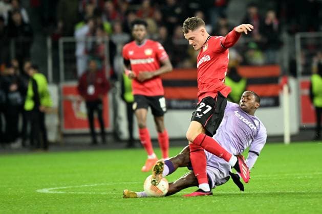 Leverkusen, Bayarena, 16.02.23, GER, Herren, UEFA Europa League, Bayer 04 Leverkusen - AS Monaco Bild: v. li. im Zweikampf Florian Wirtz (Leverkusen) und Mohamed Camara (AS Monaco) Nur fuer journalistische Zwecke! Only for editorial use! Gemaess den Vorgaben der DFL Deutsche Fußball Liga ist es untersagt, in dem Stadion und oder vom Spiel angefertigte Fotoaufnahmen in Form von Sequenzbildern und oder videoaehnlichen Fotostrecken zu verwerten bzw. verwerten zu lassen. DFL regulations prohibit any use of photographs as image sequences and or quasi-video. Nordrhein-Westfalen Deutschland