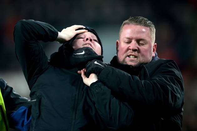 EINDHOVEN - A supporter is taken off the pitch during the UEFA Europa league play-off match between PSV Eindhoven and Sevilla FC at Phillips stadium on February 23, 2023 in Eindhoven, Netherlands. AP Dutch Height Jeroen Putmans PSV Eindhoven v Sevilla FC: Knockout Round Play-Off Leg Two - UEFA Europa League 2022 2023 xVIxANPxSportx xJeroenxPutmansxIVx 463453602 originalFilename: 463453602.jpg