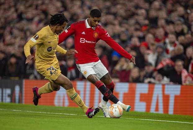 Football - UEFA Europa League - Play-Off 2nd Leg - Manchester United, ManU FC v FC Barcelona, Barca MANCHESTER, ENGLAND - Thursday, February 23, 2023: Manchester United s Marcus Rashford (R) takes on Barcelona s Jules KoundÃ during the UEFA Europa League Play-Off 2nd Leg game between Manchester United FC and FC Barcelona at Old Trafford. MANCHESTER Old Trafford GREATER MANCHESTER ENGLAND  Copyright: xDavidxRawcliffex P2023-02-23-Man_Utd_Barcelona-21