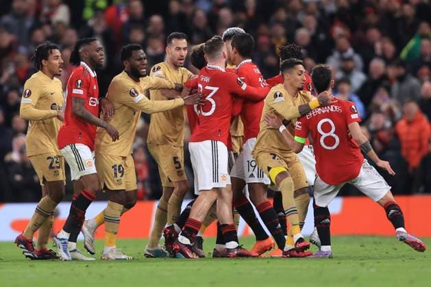 Football - UEFA Europa League - Round of 32 (2nd Leg) - Manchester United, ManU v FC Barcelona, Barca 23rd February 2023 - UEFA Europa League - Round of 32 (2nd Leg) - Manchester United v FC Barcelona - Raphinha of Barcelona tries to calm Bruno Fernandes of Manchester United as tempers flare - Photo: Simon Stacpoole Offside. Manchester UK Copyright: xSimonxStacpoolexOffside
