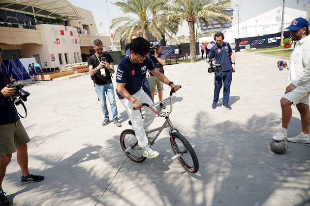 04.03.2023, Bahrain International Circuit, Sakhir, Formula 1 Gulf Air Bahrain Grand Prix 2023 ,im Bild Yuki Tsunoda (JPN), Scuderia AlphaTauri mit einem Fahrrad Sakhir Bahrain International Circuit Bahrain