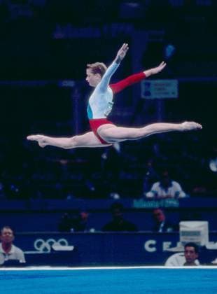 July 20-29, 1996. Atlanta, United States. Russian athlete Svetlana Khorkina (gold medal in individual uneven bars competition) performs during the 1996 Summer Olympics at the Georgia Dome. The exact date of the photograph is unknown. Robert Maximov TASS  57399153