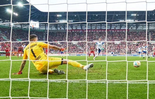 Sport Themen der Woche KW11 Sport Bilder des Tages Marius Bülter, S04 11 scores, shoots goal , Tor, Treffer, Torschuss, 1-1, 11m against Rafal GIKIEWICZ, goalkeeper FCA 1 in the match FC AUGSBURG - FC SCHALKE 04 1.German Football League on Mar 18, 2023 in Augsburg, Germany. Season 2022 2023, matchday 24, 1.Bundesliga, 24.Spieltag