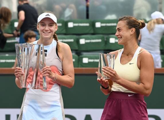 INDIAN WELLS, CA - MARCH 19: Elena Rybakina of Kazakstan with the championship trophy and Arena Sabalenka holding the runner-up trophy on center court after the finals of the BNP Paribas Open tennis tournament played on March 19, 2023 at the Indian Wells Tennis Garden in Indian Wells, CA. (Photo by John Cordes Icon Sportswire) TENNIS: MAR 19 BNP Paribas Open Icon506230319014