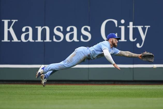 Kansas City Royals center fielder Kyle Isbel (28) misses a diving catch against the Minnesota Twins during the sixth inning on Opening Day at Kauffman Stadium in Kansas City, Missouri on Thursday, March 30, 2023.  KCP20230330121 KYLExRIVAS