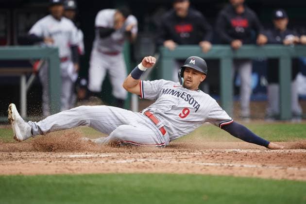 Minnesota Twins left fielder Trevor Larch (9) scores against the Kansas City Royals during the seventh inning on Opening Day at Kauffman Stadium in Kansas City, Missouri on Thursday, March 30, 2023.  KCP20230330124 KYLExRIVAS
