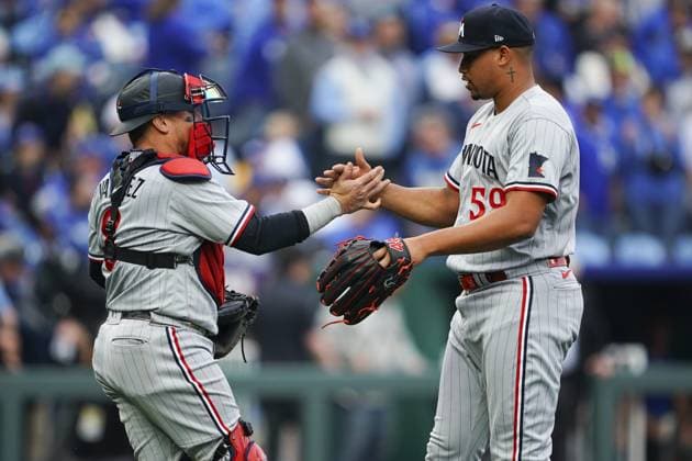 Minnesota Twins relief pitcher Jhoan Duran (59) celebrates with catcher Christian Vazquez (8) after defeating the Kansas City Royals on Opening Day at Kauffman Stadium in Kansas City, Missouri on Thursday, March 30, 2023.  KCP20230330133 KYLExRIVAS