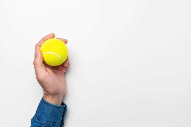 yellow tennis ball in a male hand on a white background, a place for your advertising, a mockup for a banner yellow tennis ball in a male hand on a white background, a place for your advertising, a mockup for a banner. (License=RF) 19361895 Copyright: xZoonar.com IanxIankovskiix 19361895