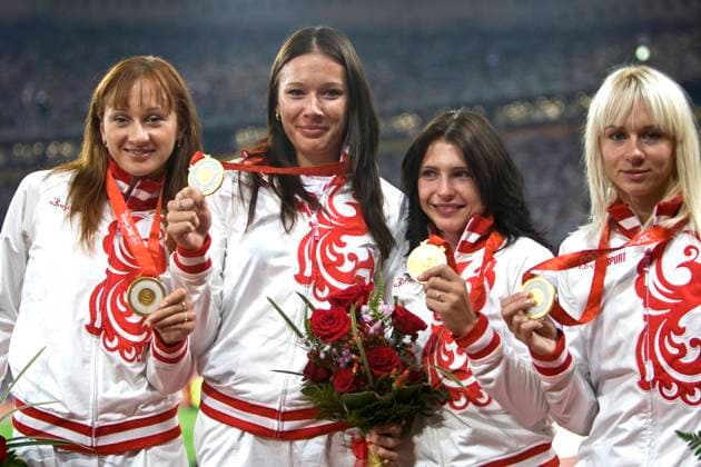 Beijing, China. Russian athletes Alexandra Fedoriva, Yulia Chermoshanskaya, Yevgenia Polyakova and Yulia Gushchina (L-R) win gold medals in the 4x100 metres relay race pose for a photo during the award ceremony of the 2008 Summer Olympics at the National Stadium (the Bird s Nest). Robert Maximov TASS  58124565
