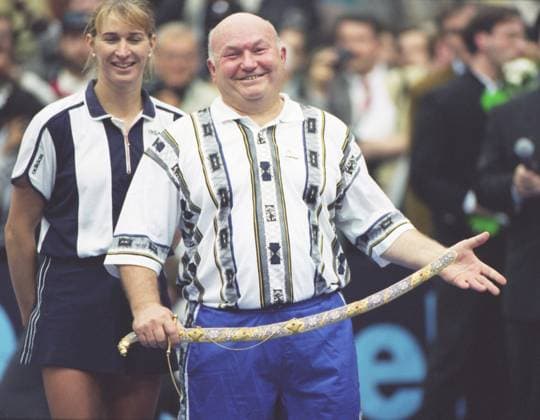Moscow, Russia. German tennis player Steffi Graf Moscow Mayor, Premier of the Moscow Government Yuri Luzhkov, who played against Chairman of the Council of Directors of the Tournament, President of the Tennis Federation of Russia Shamil Tarpishchev and tennis player from Latvia Larisa Savchenko-Neiland take part in the solemn tennis event of the 1996 Kremlin Cup in the Olympic Sports Complex. After the victory against Tarpischev - Savchenko duet Yuri Luzhkov gifted his tennis partner Steffi Graf a collection saber. Robert Maximov TASS  58383220