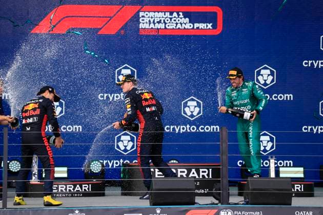 MIAMI GARDENS, FL - MAY 07: Oracle Red Bull Racing driver Sergio Perez 11 , Oracle Red Bull Racing Honda driver Max Verstappen 1 and Aston Martin Aramco Cognizzant driver Fernando Alonzo 14 spray champagne after the running of the Formula 1 Crypto.com Miami Grand Prix at Miami International Autodrome in Miami Gardens, FL. (Photo by Jeff Robinson Icon Sportswire) AUTO: MAY 07 F1 Crypto.com Miami Grand Prix EDITORIAL USE ONLY Icon23050747031