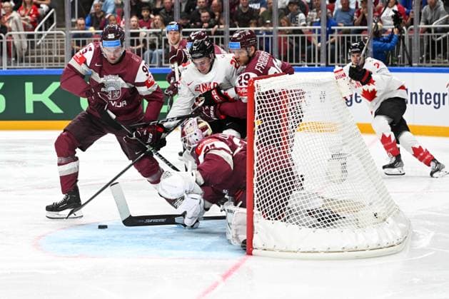 RIGA, LATVIA - MAY 12: Jack Quinn of Canada fights for the puck against Oskars Batna of Latvia (L), Ralfs Freibergs of Latvia (R) and goalkeeper Ivars Punnenovs of Latvia during the 2023 IIHF Ice hockey, Eishockey World Championship, WM, Weltmeisterschaft Finland - Latvia game between Latvia and Canada at Arena Riga on May 12, 2023 in Riga, Latvia. Riga Arena Riga Latvia Copyright: xJustPictures.ch AndreaxBrancax