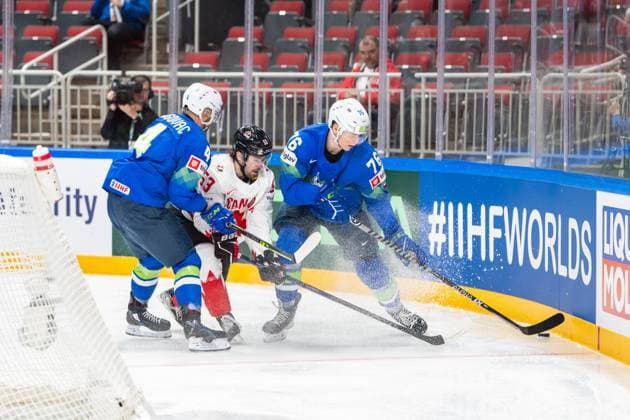 RIGA, LATVIA - MAY 14: Kristjan Cepon of Slovenia (R) held by Aleksandar Magovac of Slovenia (L) to defend the puck from Michael Carcone of Canada (C) during the 2023 IIHF Ice hockey, Eishockey World Championship, WM, Weltmeisterschaft Finland - Latvia game between Slovenia and Canada at Arena Riga on May 14, 2023 in Riga, Latvia. Riga Arena Riga Latvia Copyright: xJustPictures.ch JarixPestelaccix