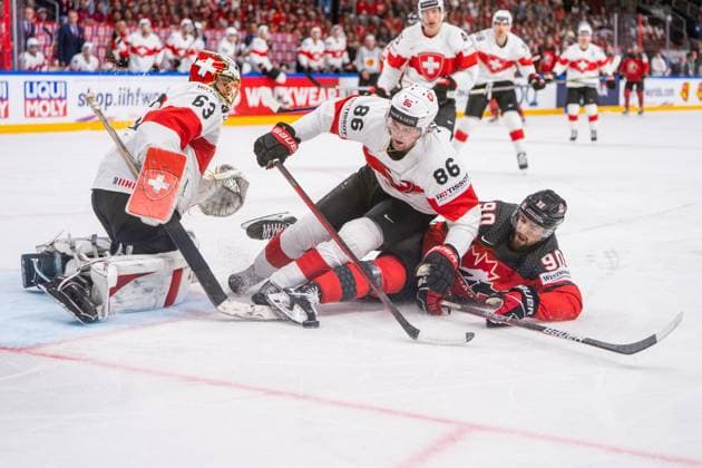 RIGA, LATVIA - MAY 20: Janis Moser of Switzerland (C) stop Joe Veleno of Canada (R) in front of goalkeeper Leonardo Genoni of Switzerland (L) during the 2023 IIHF Ice hockey, Eishockey World Championship, WM, Weltmeisterschaft Finland - Latvia game between Canada Switzerland at Arena Riga on May 20, 2023 in Riga, Latvia. Riga Arena Riga Latvia Copyright: xJustPictures.ch JarixPestelaccix