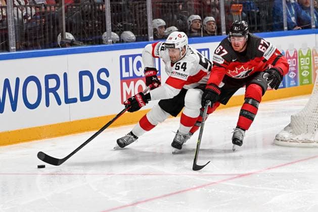 RIGA, LATVIA - MAY 20: Christian Marti of Switzerland protects the puck against Lawson Crouse of Canada during the 2023 IIHF Ice hockey, Eishockey World Championship, WM, Weltmeisterschaft Finland - Latvia game between Canada Switzerland at Arena Riga on May 20, 2023 in Riga, Latvia. Riga Arena Riga Latvia Copyright: xJustPictures.ch AndreaxBrancax
