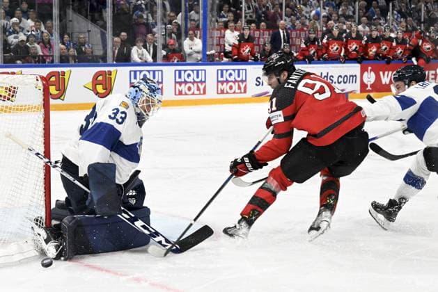 Goalkeeper Emil Larmi of Finland makes a save on a shot from Adam Fantilli (91) of Canada during the 2023 IIHF Ice hockey, Eishockey World Championships quarterfinal match between Canada and Finland in Tampere on May 25, 2023. Tampere Finland LKFTJK20230525212632CHFI  Copyright: xEmmixKorhonenx LKFTJK20230525212632CHFI