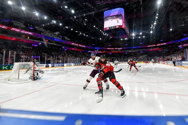 RIGA, LATVIA - MAY 27: Jake Neighbours of Canada in a battle for the puck with Ralfs Freibergs of Latvia during the 2023 IIHF Ice hockey, Eishockey World Championship, WM, Weltmeisterschaft Finland - Latvia game between Canada and Latvia at Nokia Arena on May 27, 2023 in Tampere, Finland. Tampere Finland Copyright: xJustPictures.ch AndreaxBrancax