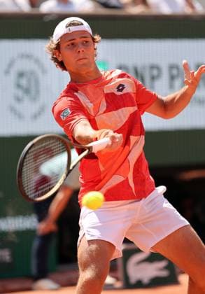 Aleksandar Kovacevic of the US returns the ball to Serbian Novak Djokovic during their first-round match at Roland Garros French Tennis Open in Paris, France, on Monday, May 29, 2023. Djokovic won 6-3, 6-2, 7-6.  PAR20230529524 MAYAxVIDON-WHITE