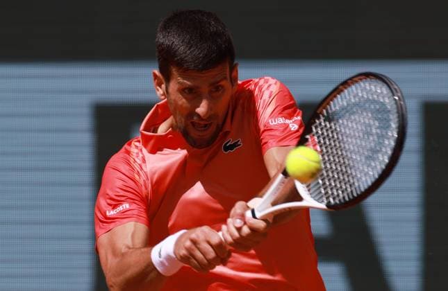 (230530) -- PARIS, May 30, 2023 -- Novak Djokovic of Serbia returns the ball during the men s singles first round match between Novak Djokovic of Serbia and Aleksandar Kovacevic of the United States at the French Open tennis tournament at Roland Garros in Paris, France, on May 29, 2023. ) (SP)FRANCE-PARIS-TENNIS-ROLAND GARROS-FRENCH OPEN-MEN S SINGLES GaoxJing 