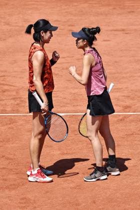 Wang Xinyu (red), CHN, and Hsieh Su-Wei (pink), TPE, during womens doubles at 2023 French Open at Roland Garros, Paris, 05 06 2023; -