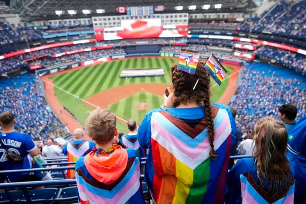 Sport Themen der Woche KW23 Sport Bilder des Tages June 9, 2023, TORONTO, ON, CANADA: Fans wearing pride themed flags stand during the national anthems to celebrate Pride Weekend before the Toronto Blue Jays play the Minnesota Twins in MLB, Baseball Herren, USA American League baseball action in Toronto on Friday, June 9, 2023. Canada News - June 9, 2023  - ZUMAc35_ 20230609_zaf_c35_252 Copyright: xMarkxBlinchx