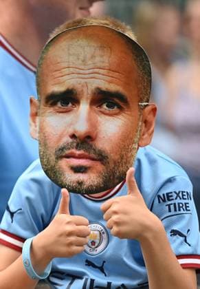 Manchester, England, 12th June 2023. A young fan in a Josep Guardiola mask waits for his heroes to arrive before their Treble winning Victory Parade ending at the Town Hall, Manchester. Picture credit should read: Gary Oakley Sportimage EDITORIAL USE ONLY. No use with unauthorised audio, video, data, fixture lists, club league logos or live services. Online in-match use limited to 120 images, no video emulation. No use in betting, games or single club league player publications. SPI-2484-0008
