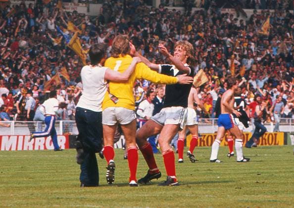 Football - 1977 British Home Championship - England 1 Scotland 2 Scotland goalkeeper Alan Rough celebrates with teammate Gordon McQueen after victory at Wembley. Scotland s victory ensured the won the championship for the second consecutive year. 04 06 1977 