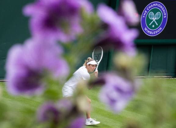 Belgian Elise Mertens pictured in action, seen through purple flowers, during a training session ahead of the 2023 Wimbledon grand slam tennis tournament at the All England Tennis Club, in south-west London, Britain, Friday 30 June 2023. BENOITxDOPPAGNE  x69761912x