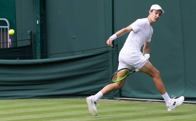 Belgian Joran Vliegen returns a ball through his legs during a training session ahead of the 2023 Wimbledon grand slam tennis tournament at the All England Tennis Club, in south-west London, Britain, Saturday 01 July 2023. BENOITxDOPPAGNE  x69842948x