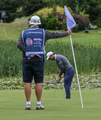 2nd July 2023; The Belfry, Sutton Coldfield, West Midlands, England: Betfred British Masters Golf, Day 4; Edoardo Molinari s caddy holds the flag while he putts  ActionPlus12526237 GodfreyxPitt