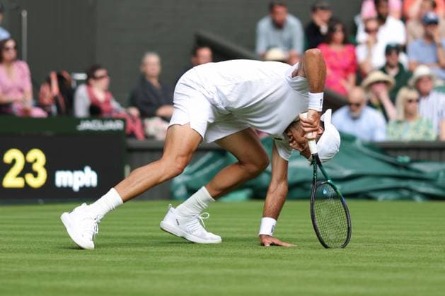 Day One: The Championships - Wimbledon 2023 LONDON, ENGLAND - JULY 03: Pedro Cachin (ARG) slips due to the rain during his Gentlemen s Singles 1st Round match against Novak Djokovic (SRB) during day one of The Championships Wimbledon 2023 at All England Lawn Tennis and Croquet Club on July 3, 2023 in London, England. London England United Kingdom Copyright: xCharlottexWilson OffsidexOffside 775939806