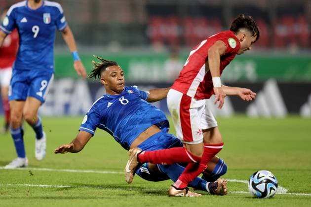 TA™QALI, MALTA JULY 3: Italy Under-19 soccer player Cher N™Dour (L) vies for the ball with Malta™s Andrew Borg (R) during the UEFA European Under-19 Championship 2022 23 Group A match between Malta and Italy at National Stadium on July 3, 2023, in Ta™Qali, Malta. UEFA European Under-19 Championship 2022 23 Final Tournament in Malta UEFA_U19_2023