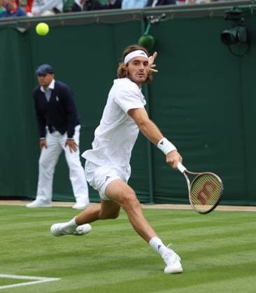 Greek Stefanos Tsitsipas plays a backhand during his first round match against Austria s Dominic Thiem on day two of the 2023 Wimbledon championships in London on Tuesday, July 04, 2023.  LON2023070401 HUGOxPHILPOTT