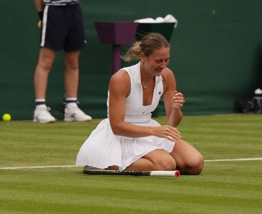 Tennis - 2023 Wimbledon Championships - Week One - Day Three - All England Lawn Tennis & Croquet Club, Wimbledon - Wednesday 5th July 2023 Maria Sakkari (GRE) v Marta Kostyuk (UKR) Marta Kostyuk (UKR) drops to her knees as she celebrates winning match point 