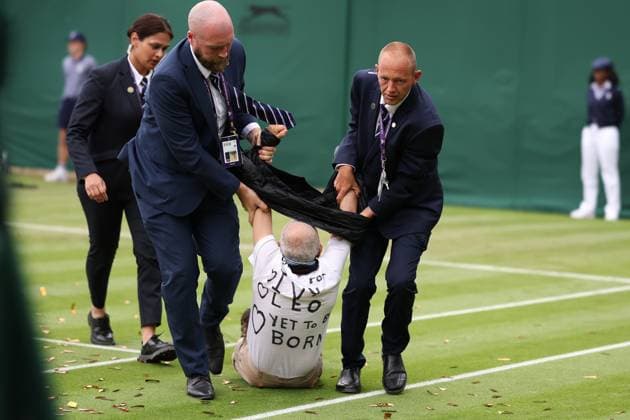 5th July 2023; All England Lawn Tennis and Croquet Club, London, England: Wimbledon Tennis Tournament; The Just Oil Protestor is removed by Wimbledon security  ActionPlus12527321 ShaunxBrooks