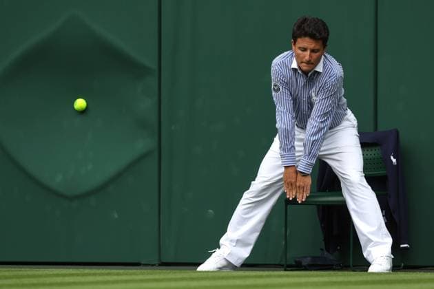 Wimbledon: Day Three 5 July 2023, Wimbledon - Wimbledon Tennis Championships - Day Three - A line judge calls the ball in as it slams into the green backing - Photo: Charlotte Wilson Offside . Wimbledon UK Copyright: xCharlottexWilsonx xOffsidexOffside