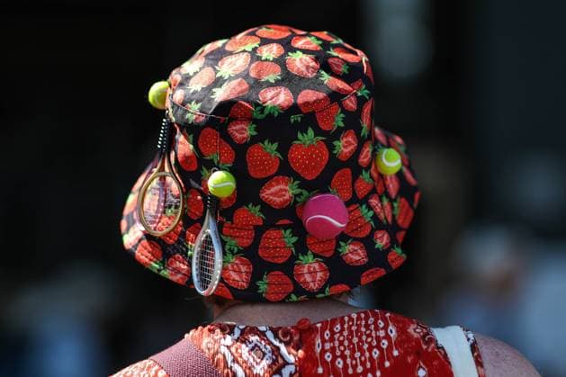 Wimbledon: Day Five 7 July 2023, Wimbledon - Wimbledon Tennis Championships - Day Five - A spectator with a strawberry bucket hat covered in miniature tennis balls and rackets - Photo: Charlotte Wilson Offside. Wimbledon UK Copyright: xCharlottexWilsonx xOffsidexOffside