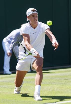 Denmark s Holger Rune plays a forehand in his second round match against Spain s Roberto Carballes Baena on day five of the 2023 Wimbledon championships in London on Friday, July 07, 2023.  LON2023070703 HUGOxPHILPOTT