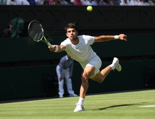 Spain s Carlos Alcaraz plays a forehand in his third round match against France s Alexandre Muller on day five of the 2023 Wimbledon championships in London on Friday, July 07, 2023.  LON2023070750 HUGOxPHILPOTT